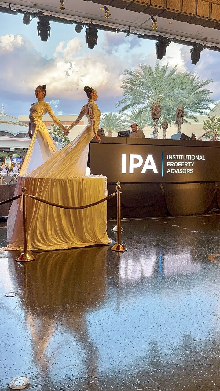 Ambiance Waves — two performers in white gowns forming a heart with silk trains