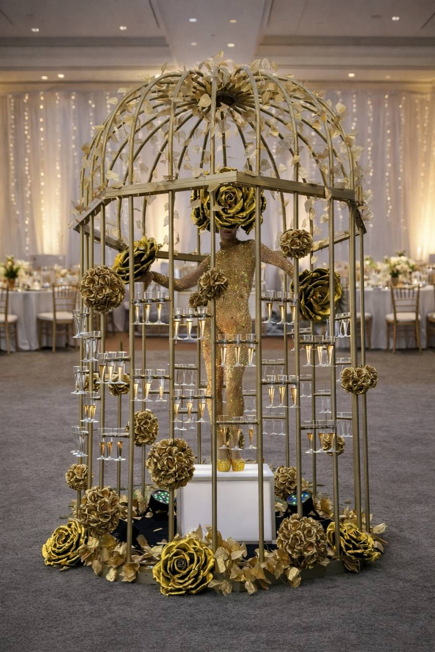 Hostess inside the gold birdcage with champagne flutes, wedding ballroom
