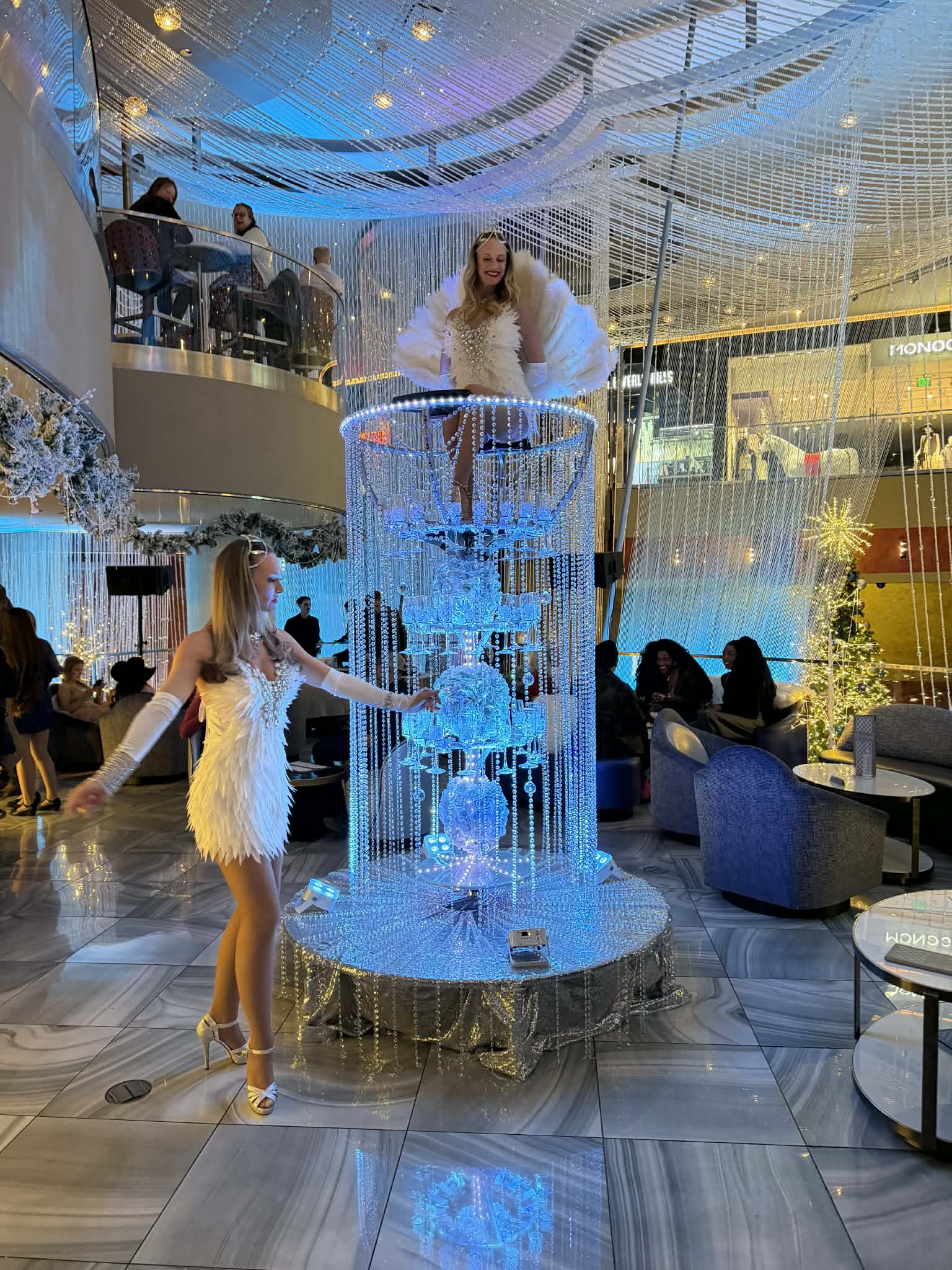 Champagne server tower with hostess in a hotel lobby
