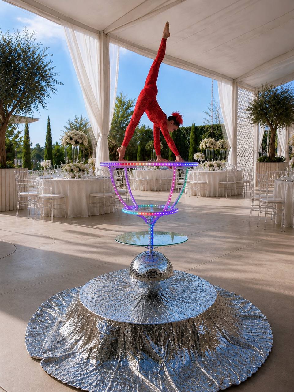 Aerialist in an inverted pose on a glowing LED prop atop the Disco Luxe Platform — Las Vegas event