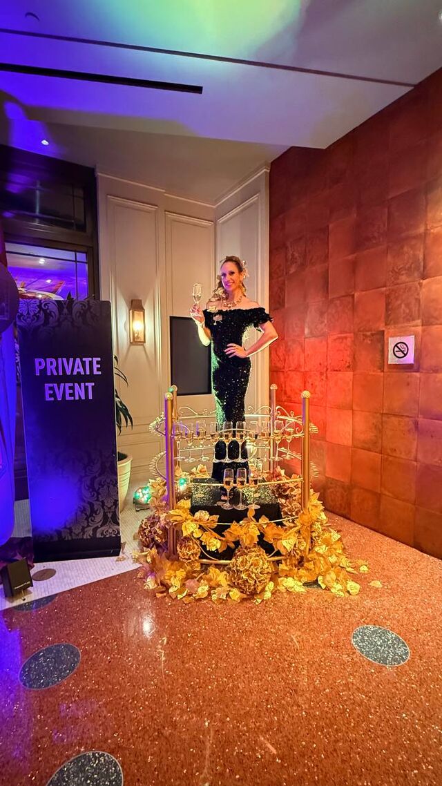 Model in a black gown inside the Elegant Champagne Station at a Las Vegas event