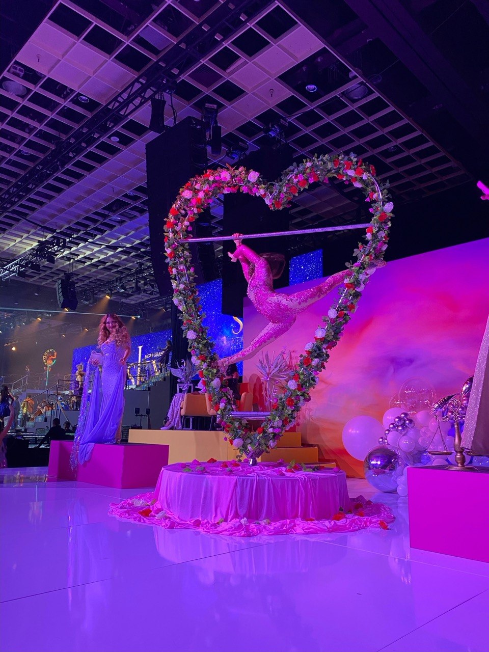 Flower-wrapped heart aerial prop with a performer at a Las Vegas event