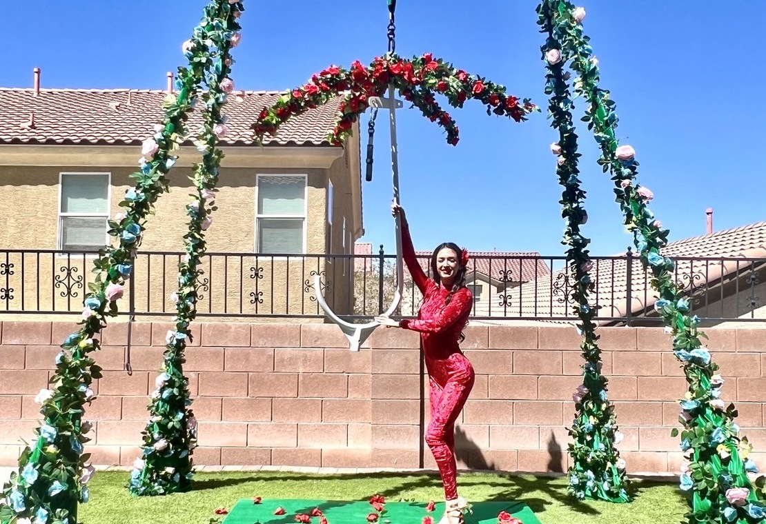 Portable aerial rigging in Floral theme — flower-covered A-frame with red heart lyra